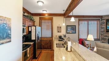 Dishwasher, coffee/tea maker, cookware/dishes/utensils, dining tables