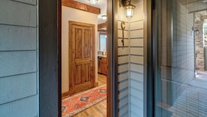 A wooden door leading to a kitchen with a red patterned rug. - Chalakee Lodge CI-1- Mountain View, Gated Resort, Indoor/Outdoor Pools & Hot Tub (Boone)