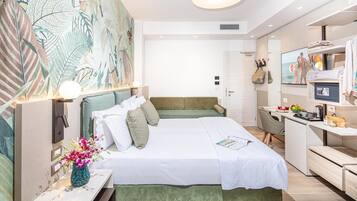 Una habitación de hotel moderna con una cama grande, un escritorio y una televisión.