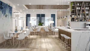 A modern kitchen with a marble countertop, wooden flooring, and a bar area with stools.