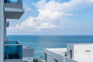 Enjoy a scenic view of the ocean from the spacious balcony with seating area.