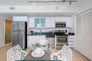 Enjoy cooking and dining in this well-equipped kitchen with a dining table for two.