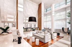 Relax in our spacious lobby, featuring a comfortable seating area, open kitchen, and large windows offering a view of the outdoors.