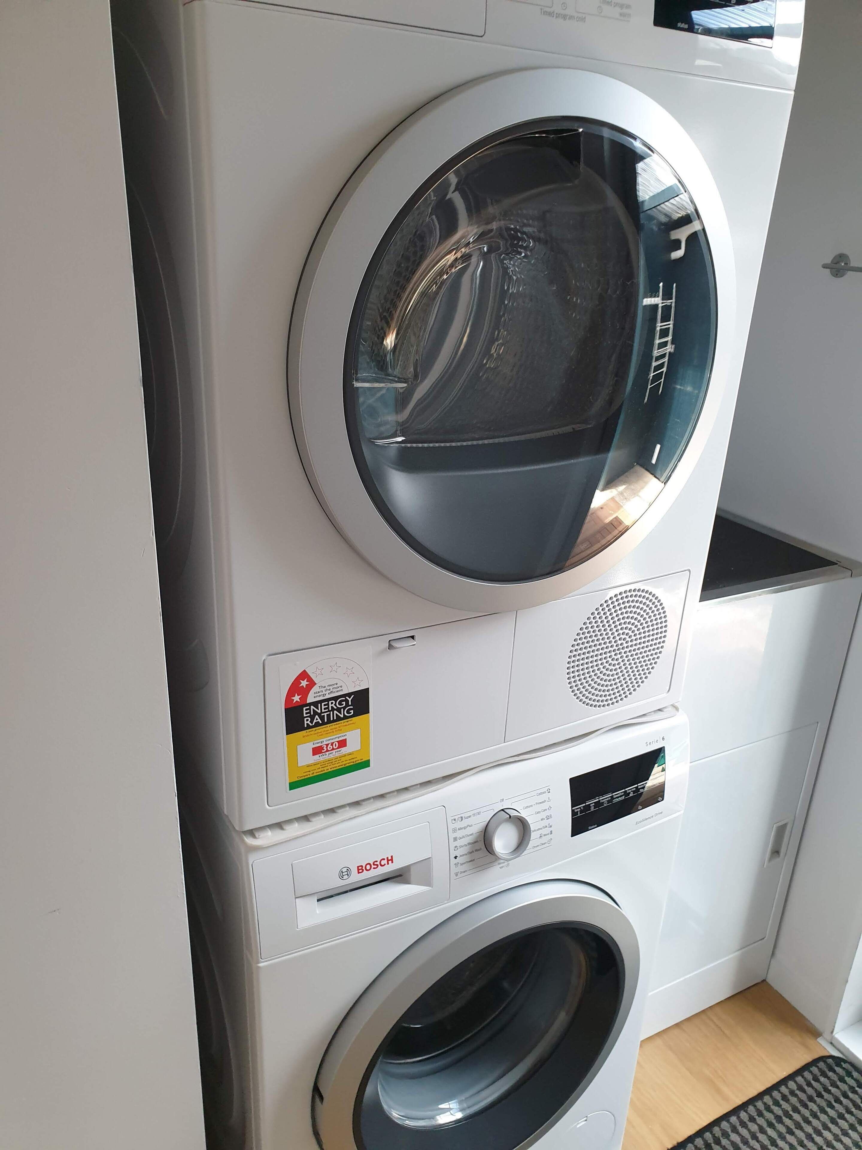 A front-loading Bosch washing machine with a circular door, a control panel, and an ENERGY STAR rating sticker.