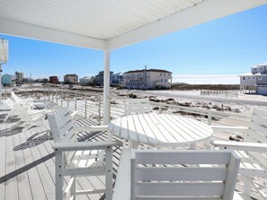Relax in a spacious outdoor seating area with a table and chairs, taking in the views of the surrounding landscape.