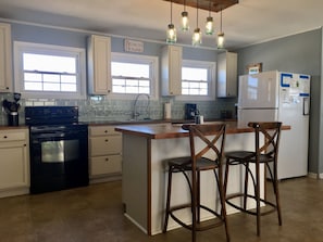 Enjoy cooking in this well-equipped kitchen with a central island and ample natural light.