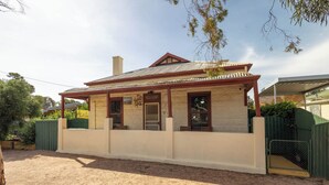 A single-story building with a corrugated metal roof, a front porch, and a sign that reads 'WELCOME'. - Hawker Bed and Breakfast (Hawker)
