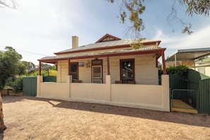 A single-story building with a corrugated metal roof, a front porch, and a sign that reads 'WELCOME'. - Hawker Bed and Breakfast (Hawker)