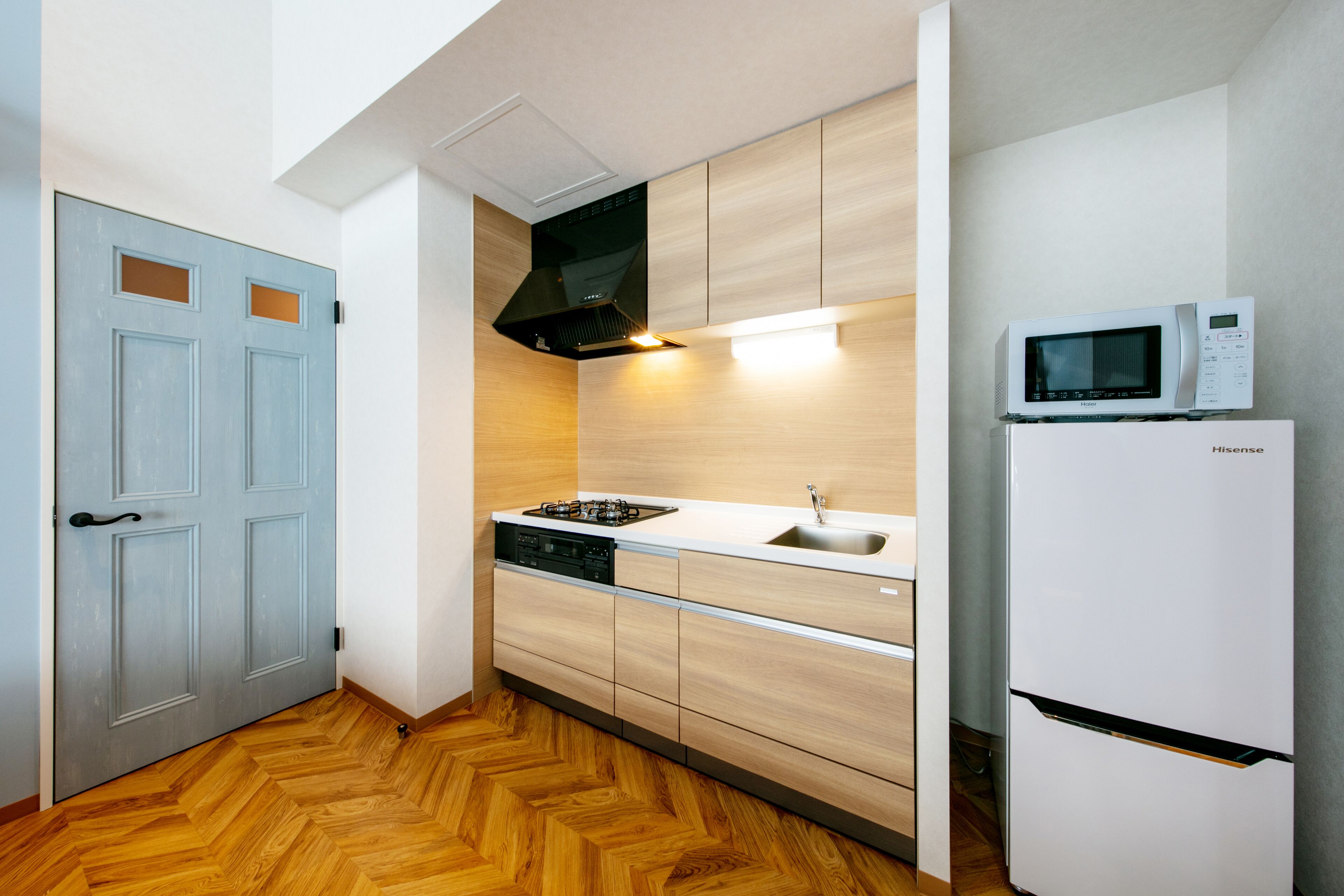 A compact kitchen with a microwave, stove, and dishwasher.
