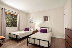 A room with two single beds, a nightstand with a lamp, a wooden dresser, and a window with curtains. - The Great Escape! Modern, Secluded Retreat, Views! (Sedona)
