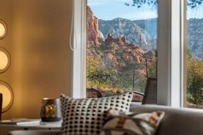 A room with a large window offering a view of red rock formations. - The Great Escape! Modern, Secluded Retreat, Views! (Sedona)
