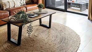 A modern living room with a leather sofa, a wooden coffee table, and a large window with a view of outdoor furniture. - 2 Spacious Resort 1BR Pool-Tennis-Gym & FREE Parkg (Perth)