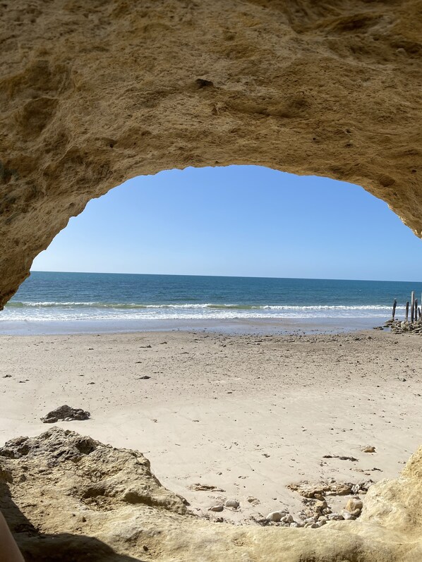 Stunning ocean views through a natural rock archway.