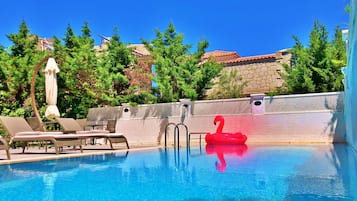 Outdoor pool, open 9:00 AM to 9:00 PM, pool umbrellas, pool loungers