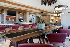 Relax in our stylish lobby, featuring a long reception desk, comfortable seating, and a large flat-screen TV.