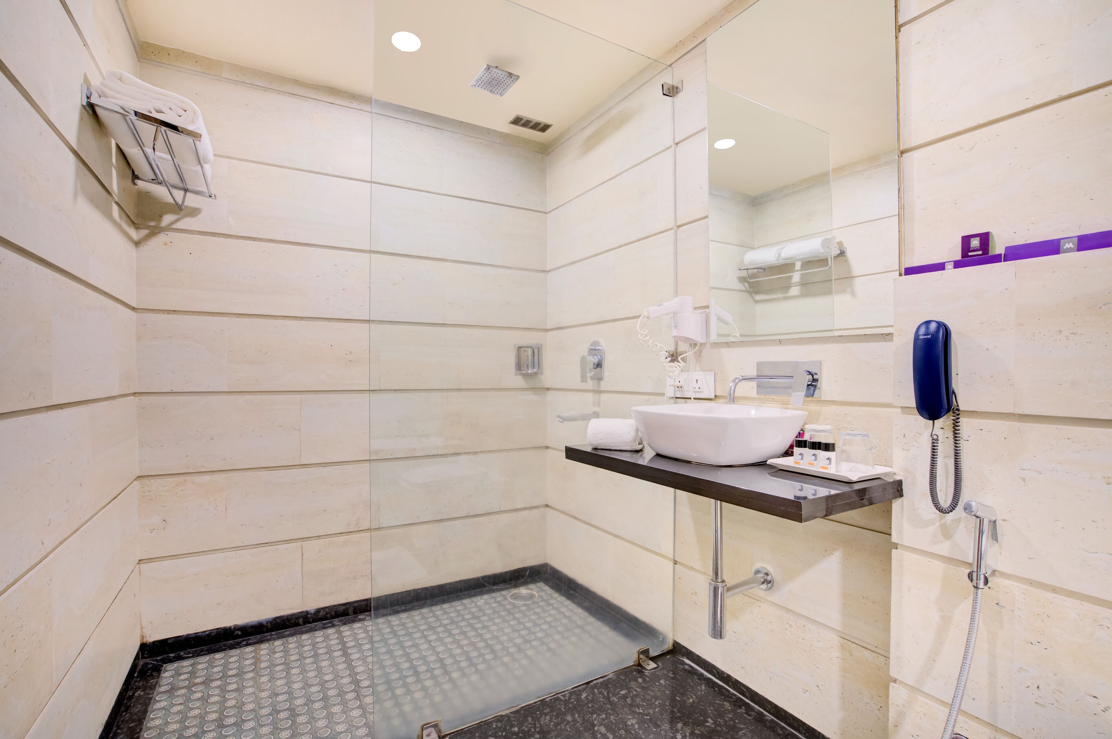 elite room | bathroom | designer toiletries, hair dryer, slippers, soap