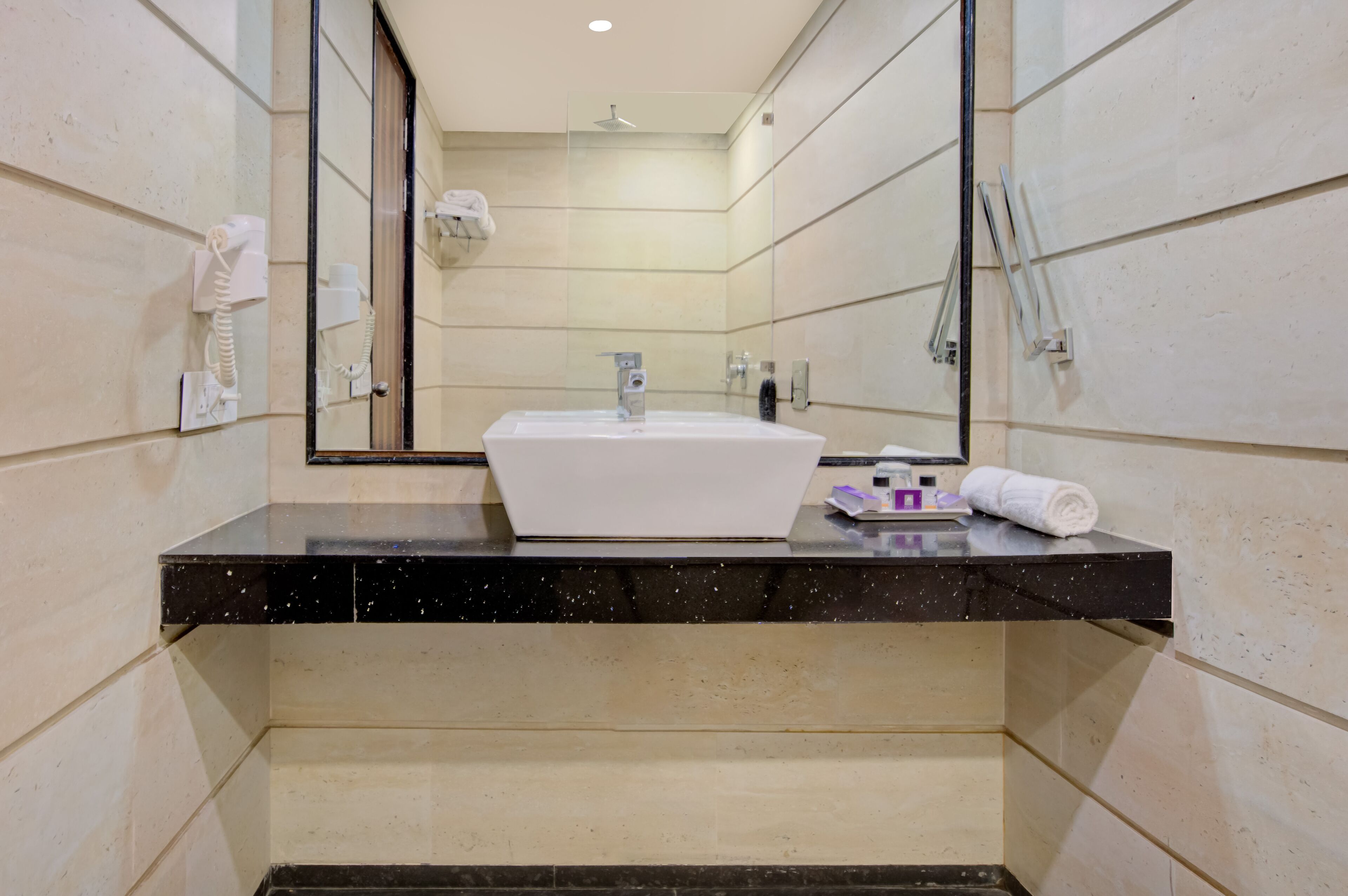 designer toiletries, hair dryer, slippers, soap