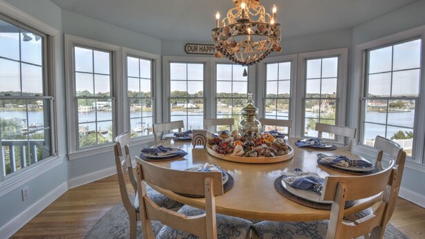 A dining room with a large table, chairs, and a chandelier. - "Haven By The Sound" - Intercoastal Waterway Home w/ Pool, 6 Bedrooms / 6.5 Bathrooms (Holden Beach)