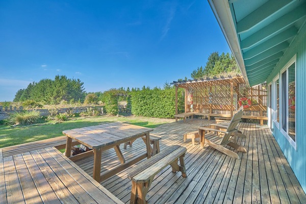 The large cedar deck with comfy Adirondack chairs and a picnic table offers a tranquil outdoor setting for this delightful retreat.