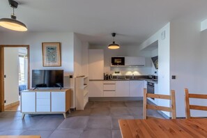 Enjoy cooking in this well-equipped kitchen with a central island, flat-screen TV, and dining area.