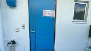 A blue door with a sign reading "NAGO Sakura Resort Inn 201". - Nago Sakura Resort Inn (名護市)