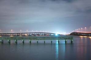 A long bridge over calm water with evenly spaced supports and a series of lights along its length. - Tropical Waterfront Villa with Heated Pool & Spa (Punta Gorda)