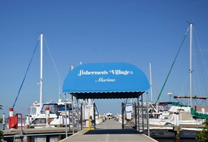 A marina with a blue canopy labeled 'Fishermen's Village Marina' and boats docked around. - Tropical Waterfront Villa with Heated Pool & Spa (Punta Gorda)
