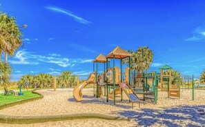 Kids can play on the playground's slide and climbing elements.