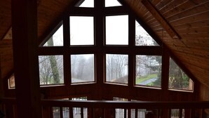 A room with a high, sloped ceiling and large, triangular windows.