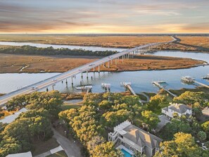 A bridge over a water body with a residential area in the foreground.