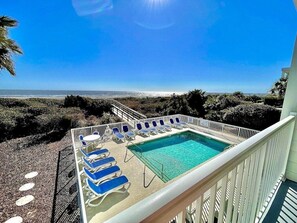 Enjoy the ocean view from our rooftop pool surrounded by lounge chairs.