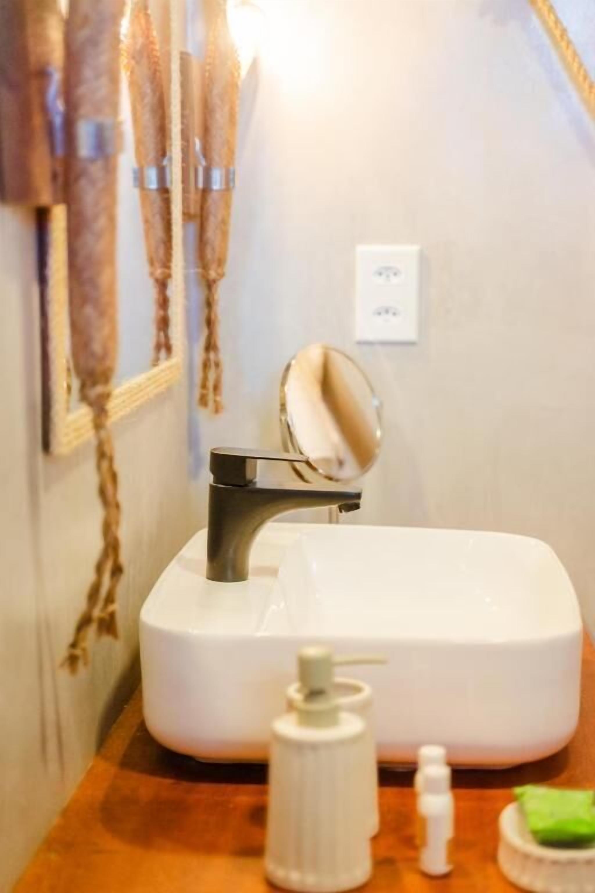 Ein Badezimmer mit Waschbecken, Spiegel und Handtuchhalter.