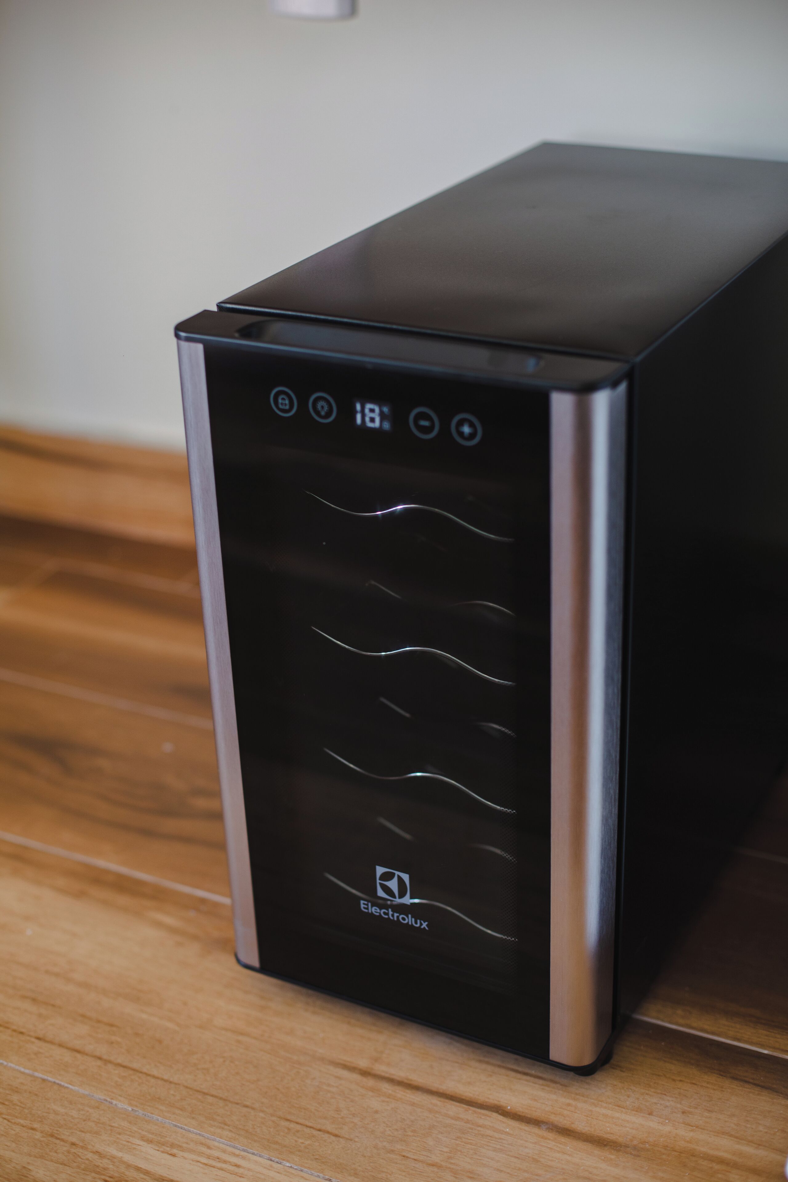 A black and silver electric vehicle charging station with a digital display.