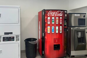A vending machine with Coca-Cola and Sprite options, a trash bin, and an ice cube dispenser. - Quality Inn Fishers - Indianapolis (Fishers)