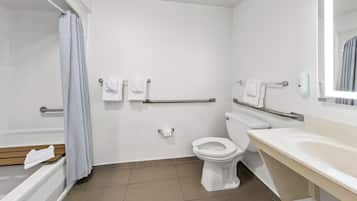 A bathroom with a toilet, a sink, a shower, and a towel rack.