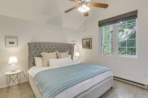 A bedroom with a large bed, a ceiling fan, a window with blinds, and a picture on the wall. - Hike, Ski & Golf: Fully Renovated Edwards Townhome (Edwards)