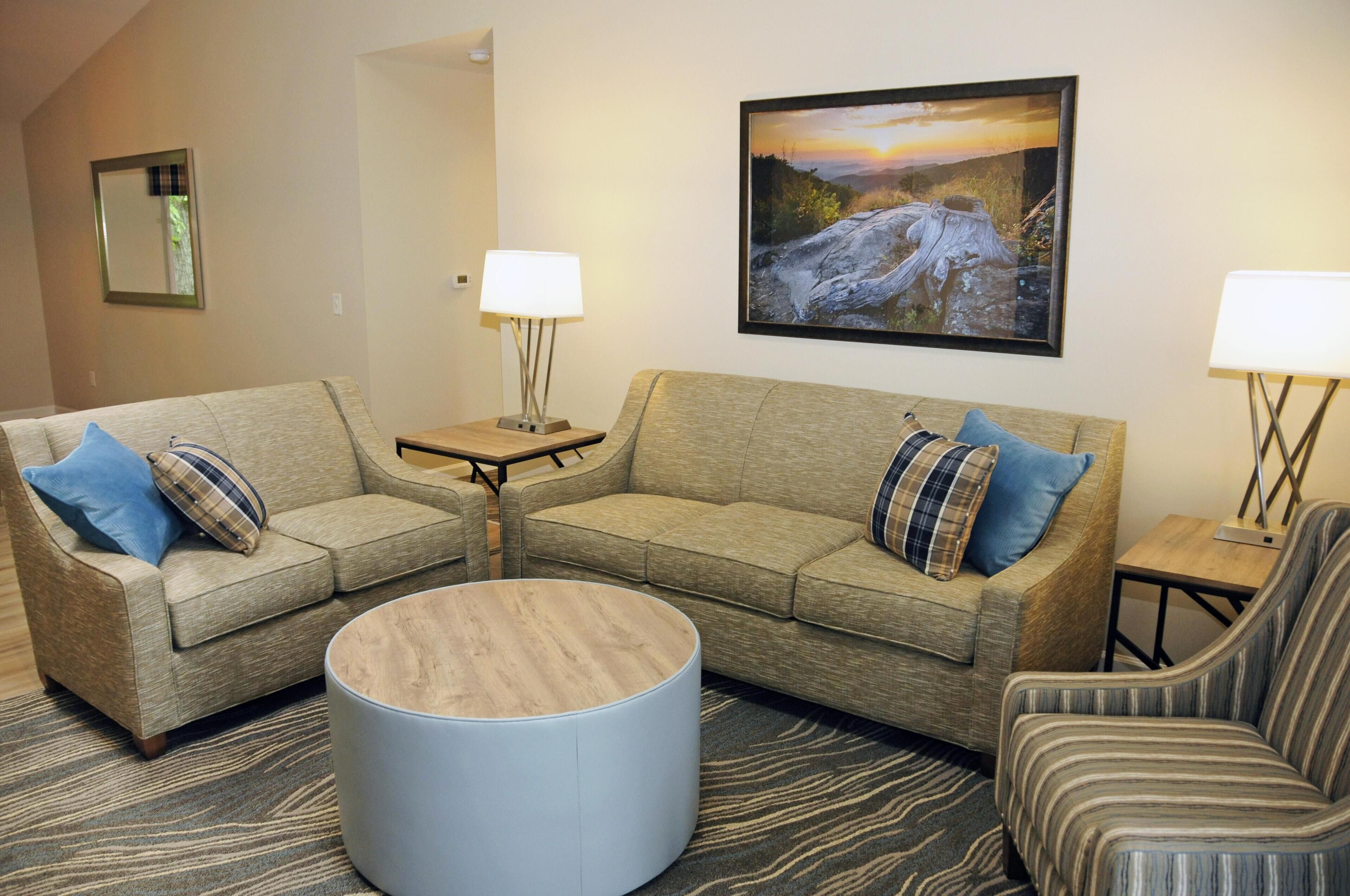 A living room with two sofas, a coffee table, and two side tables with lamps.