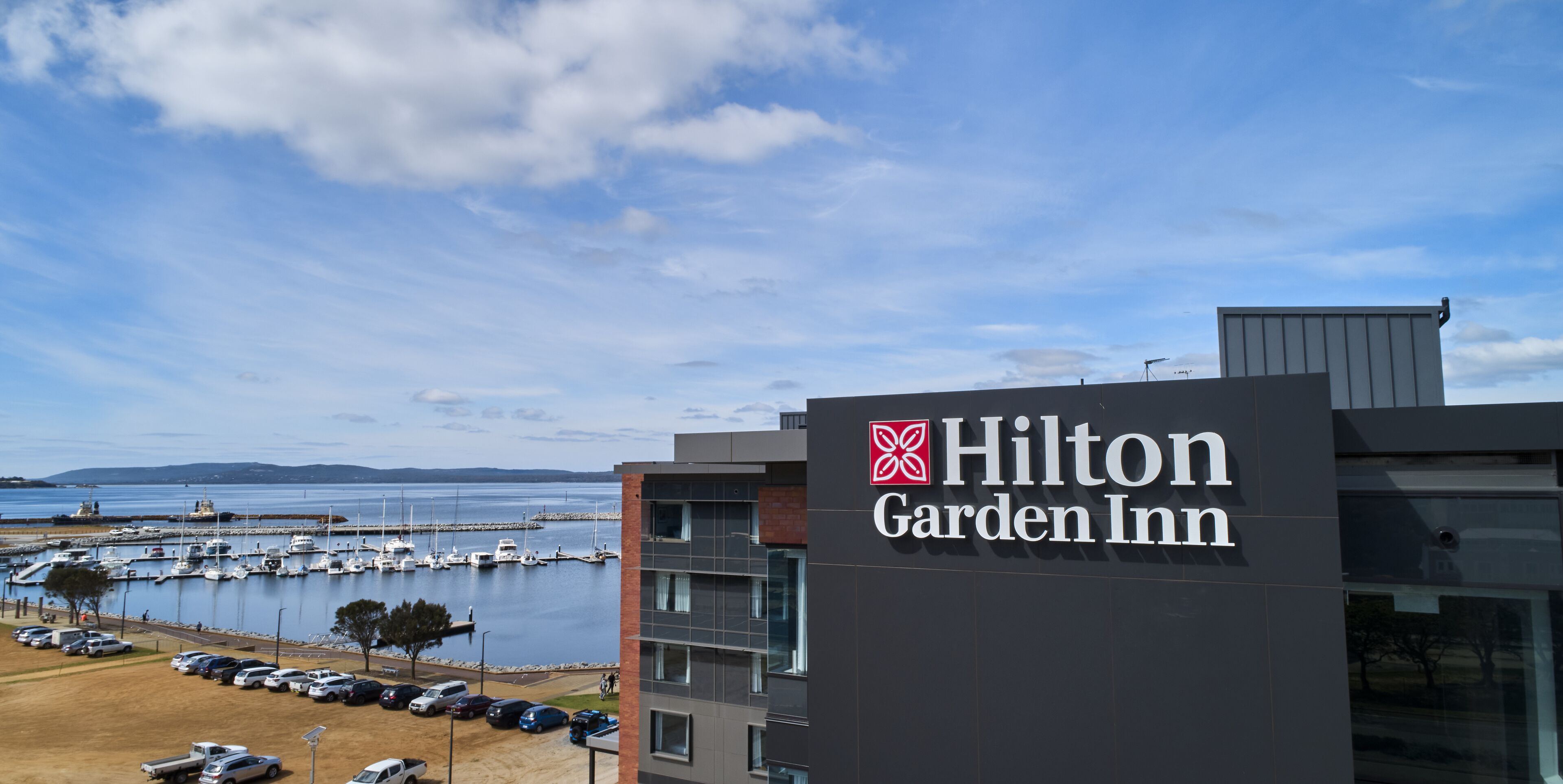 Edificio de Hilton Garden Inn con vista al puerto deportivo.
