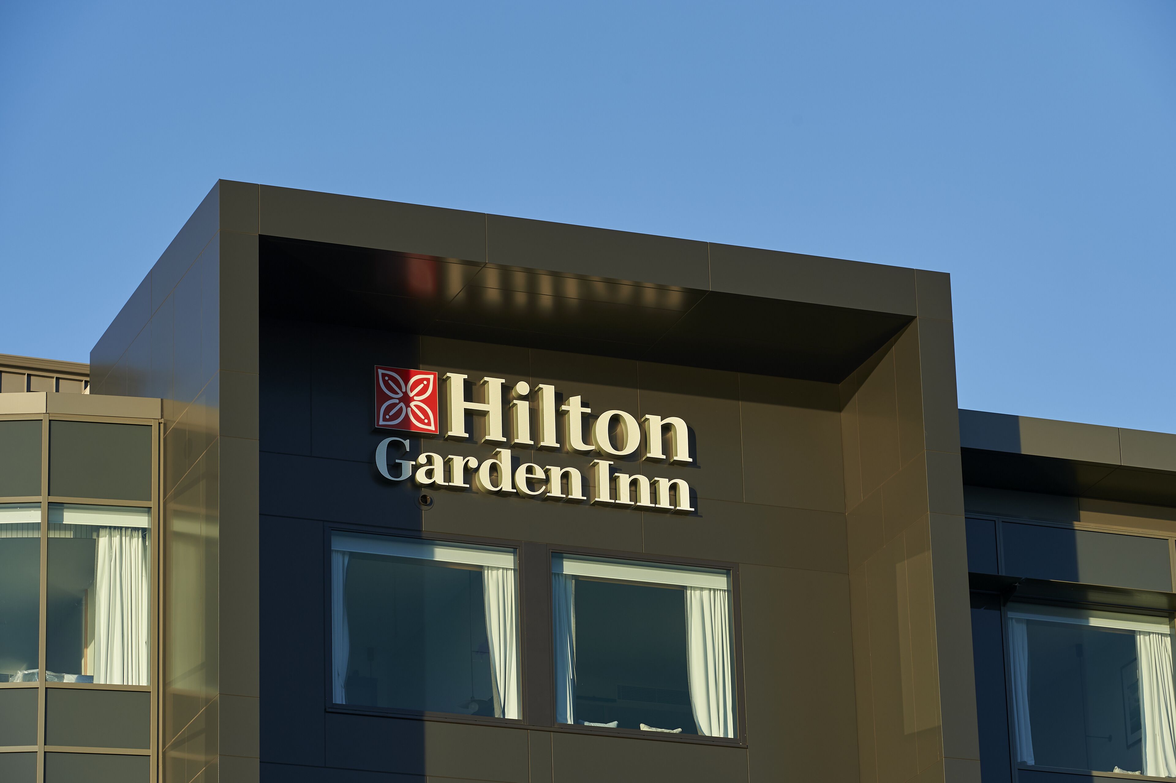 A Hilton Garden Inn sign on a building facade.