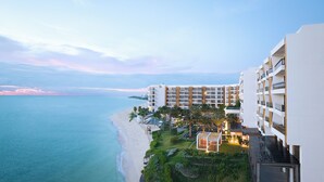 A beachfront hotel with multiple buildings, a pool area, and a view of the ocean. - Waldorf Astoria Riviera Maya (Cancun)