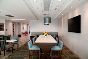 Enjoy meals with friends and family at the dining table, surrounded by comfortable seating for six.