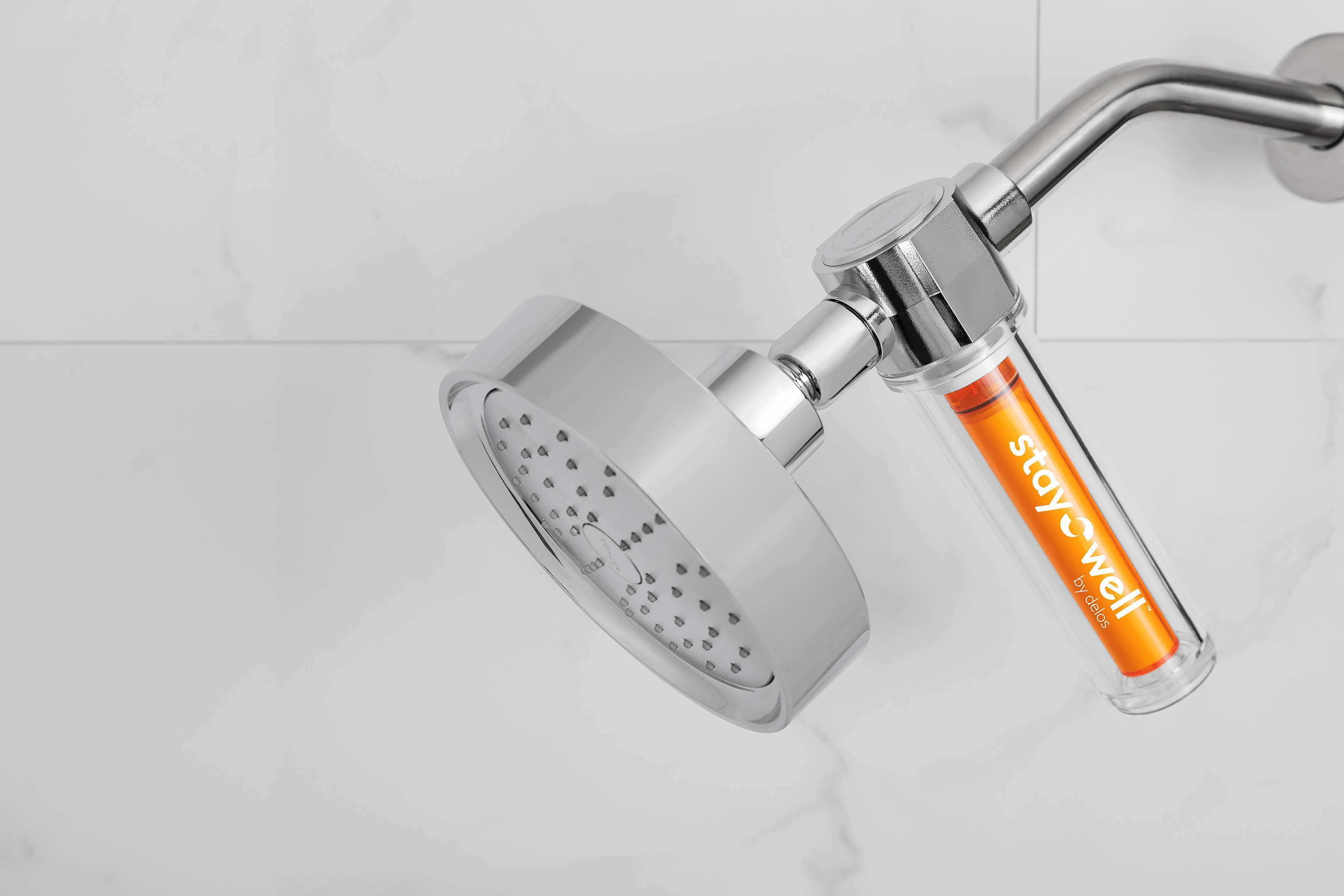 A modern showerhead with a transparent handle and a metallic finish.