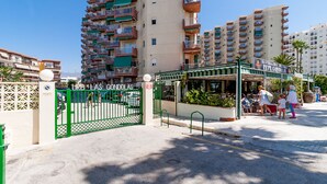 A gated entrance to a residential area with a restaurant named Pepe Gondolas. - New front line beach apartment with swimming pool, A/C and WIFI (Almuñecar)