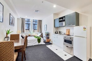Enjoy a comfortable stay in this well-appointed room with a dining area, sofa, and kitchenette.
