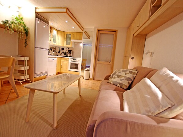A compact living space with a kitchenette, a dining area, and a seating area with a sofa and a small table. - Renovated studio 4 ppl, modern comfort, balcony (Tignes)
