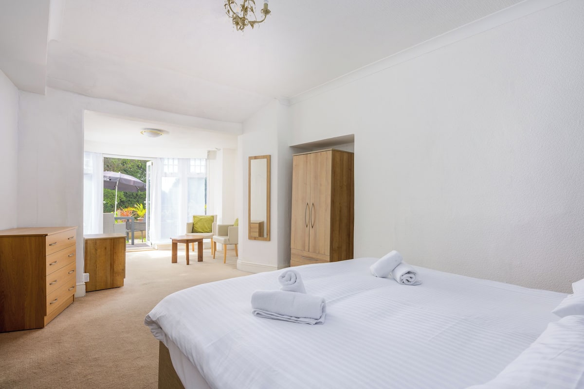 Desk, iron/ironing board, bed sheets