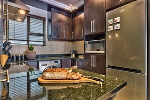 Basic Double Room | Private kitchen | Fridge, microwave, oven, stovetop - Bay Point Apartment on Beach Road (Cape Town)