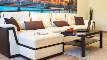 Comfort Apartment | Living room | 40-inch TV with cable channels