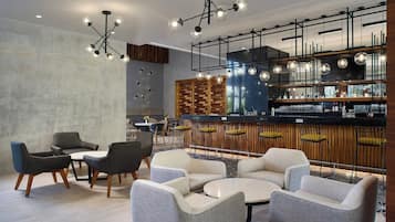 Un área de bar moderna con asientos y una barra.