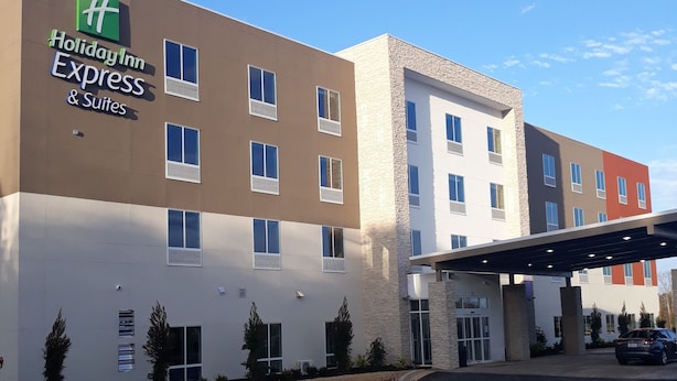 A Holiday Inn Express & Suites hotel with a modern design, featuring multiple floors and a covered parking area. - Holiday Inn Express & Suites Jackson by IHG (Jackson)